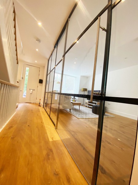 AOD Contracts (Twickenham, London): Industrial Style Interior Glass Wall With Large Sliding Door