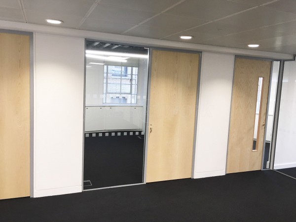 Above & Beyond Construction Ltd (Haymarket, London): Multi-Office Full Floor Fit-Out with Timber Doors & Toughened Glass Partitions