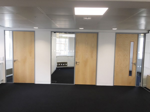 Above & Beyond Construction Ltd (Haymarket, London): Multi-Office Full Floor Fit-Out with Timber Doors & Toughened Glass Partitions