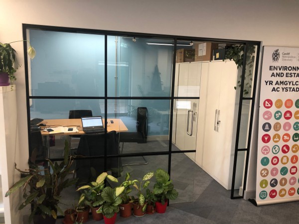 Cardiff Metropolitan University (Cardiff, Caerdydd): Industrial-Look Office Wall With Black Metal Frame and Sliding Door