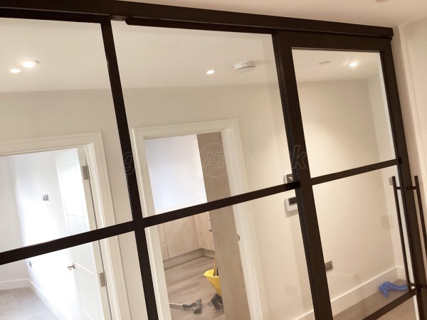 Chase New Homes Limited (Hertford, Hertfordshire): T-Bar Glazed Partitioning with Framed Sliding Door Leaves in multiple Properties