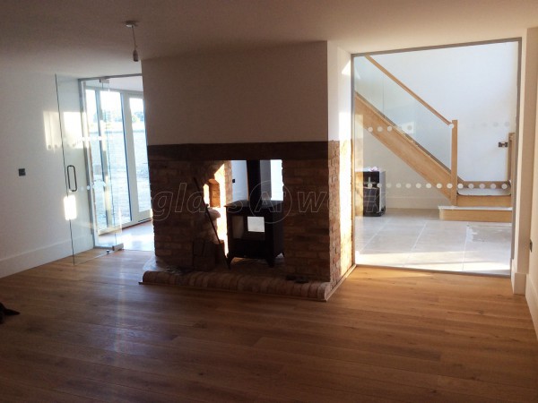Martin Haynes Construction, Domestic (Towcester, Northamptonshire): Frameless Glass Door and Wall Around Central Fireplace