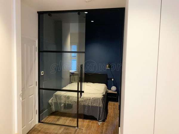 Capital Living (Clapham, London): Industrial-Style Black Metal and Glass Sliding Door For A Bedroom