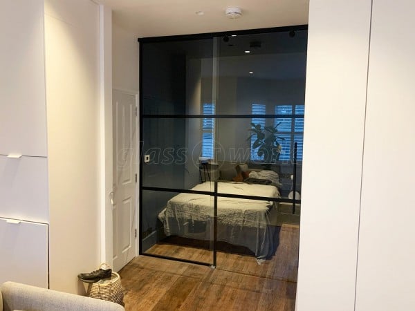 Capital Living (Clapham, London): Industrial-Style Black Metal and Glass Sliding Door For A Bedroom