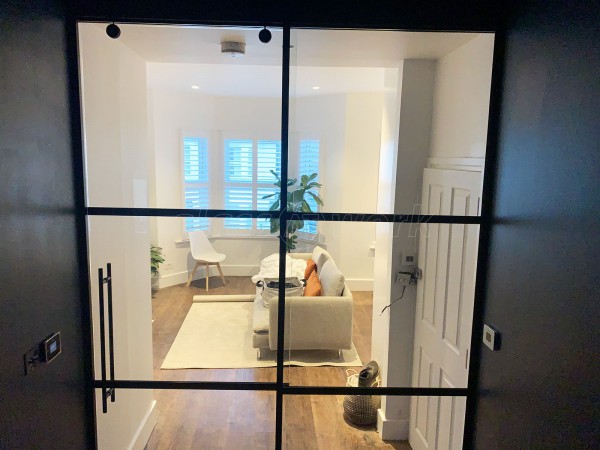 Capital Living (Clapham, London): Industrial-Style Black Metal and Glass Sliding Door For A Bedroom